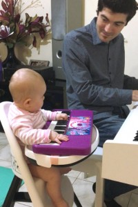 Mariah at 5 months. Hitting the keys of her little keyboard while she also watches.